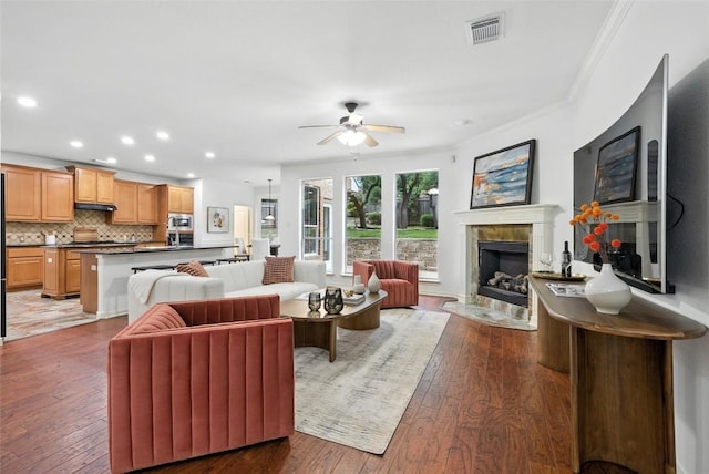 5704 Keli Ct, Austin, TX 78735 - living area with a ceiling fan, recessed lighting, light wood-type flooring, a fireplace, and crown molding