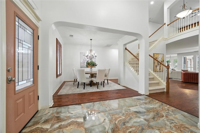 5704 Keli Ct, Austin, TX 78735 - foyer with marble tiled flooring, stairs, a towering ceiling, a chandelier, and recessed lighting