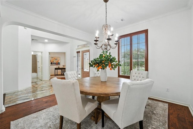 5704 Keli Ct, Austin, TX 78735 - dining space with ornamental molding, a chandelier, wood finished floors, and arched walkways