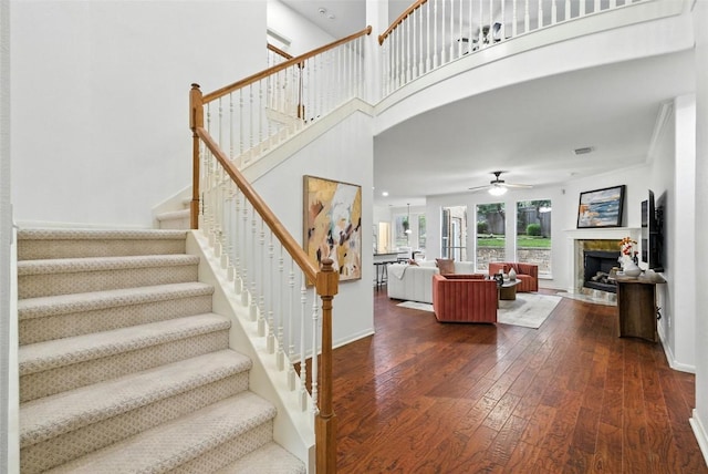 5704 Keli Ct, Austin, TX 78735 - stairway featuring wood-type flooring, a ceiling fan, and a tiled fireplace