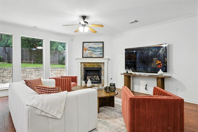 5704 Keli Ct, Austin, TX 78735 - living room with a ceiling fan, hardwood / wood-style floors, a tile fireplace, and crown molding