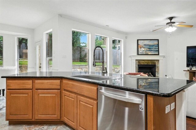 5704 Keli Ct, Austin, TX 78735 - kitchen featuring stainless steel dishwasher, open floor plan, a tiled fireplace, dark stone counters, and a ceiling fan