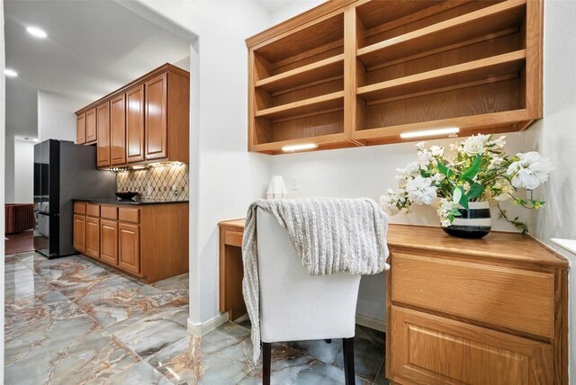 5704 Keli Ct, Austin, TX 78735 - kitchen with open shelves, light marble finish flooring, freestanding refrigerator, backsplash, and brown cabinets