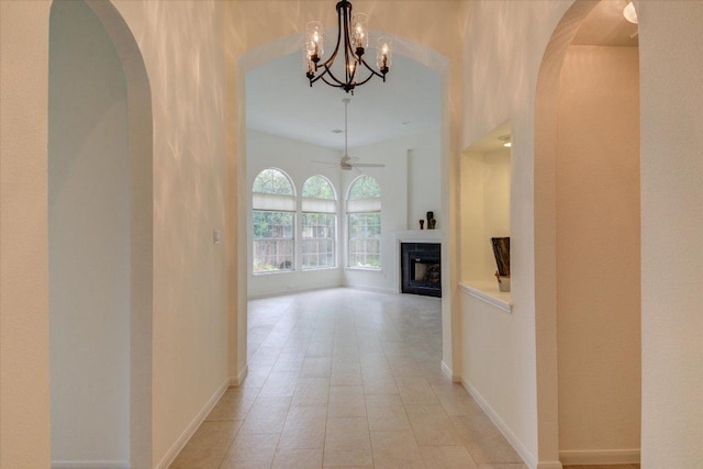 6604 Donner Cv, Austin, TX 78749 - corridor featuring arched walkways, a chandelier, and light tile patterned flooring