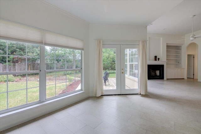 6604 Donner Cv, Austin, TX 78749 - unfurnished living room with french doors, built in features, ceiling fan, tile patterned floors, and ornamental molding