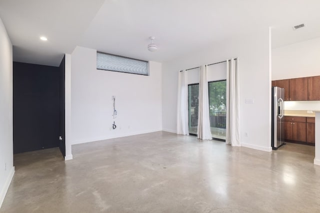 5912 Toscana Ave, Austin, TX 78724 - unfurnished living room with finished concrete flooring and recessed lighting