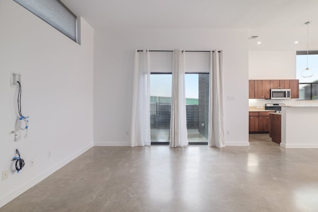5912 Toscana Ave, Austin, TX 78724 - unfurnished living room featuring plenty of natural light, finished concrete floors, and recessed lighting