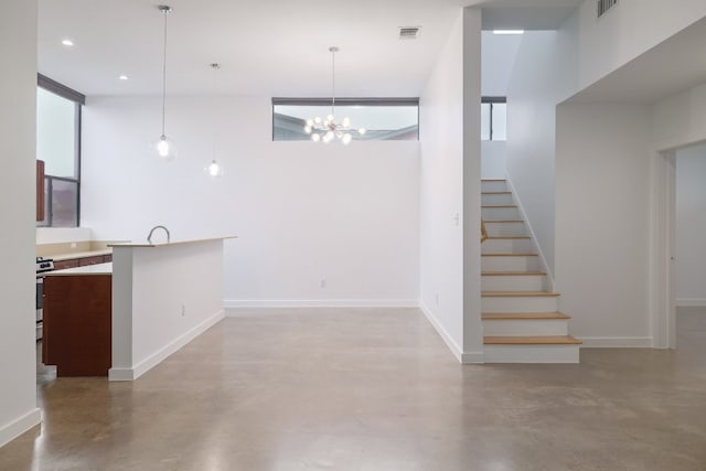 5912 Toscana Ave, Austin, TX 78724 - unfurnished living room with concrete flooring, stairway, a chandelier, and recessed lighting