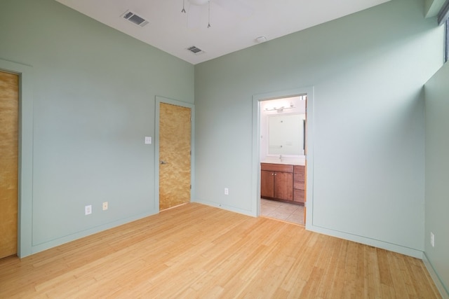 5912 Toscana Ave, Austin, TX 78724 - unfurnished bedroom with wood finished floors, ensuite bath, and ceiling fan