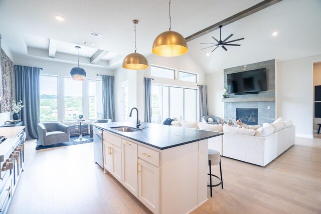 2220 Normandy Vw, Leander, TX 78641 - kitchen with beamed ceiling, light wood finished floors, a large fireplace, dishwasher, and open floor plan