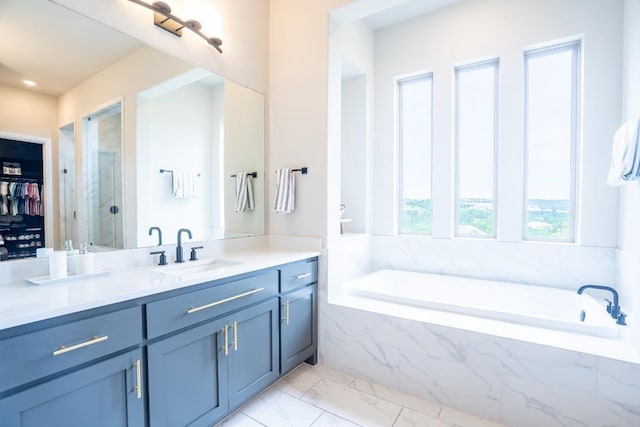 2220 Normandy Vw, Leander, TX 78641 - bathroom featuring vanity, a bath, marble finish flooring, a stall shower, and a walk in closet