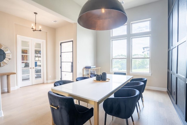 2220 Normandy Vw, Leander, TX 78641 - dining area with light wood-style floors, french doors, and a chandelier