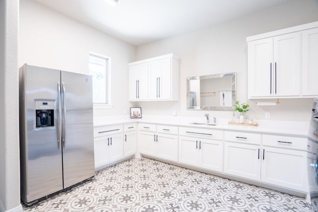 2220 Normandy Vw, Leander, TX 78641 - kitchen featuring stainless steel fridge, light countertops, and white cabinetry