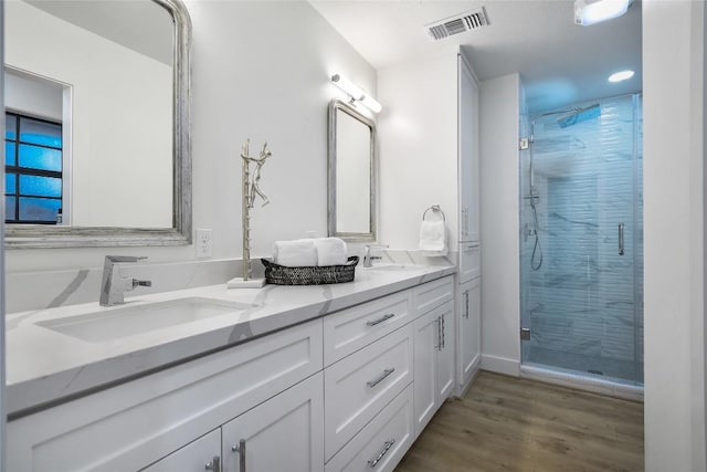 6569 Cutoff Rd, Round Top, TX 78940 - bathroom with a shower stall, double vanity, and wood finished floors