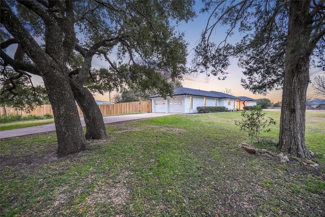 6569 Cutoff Rd, Round Top, TX 78940 - yard at dusk with driveway and a garage