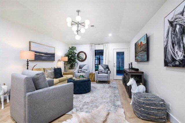 6569 Cutoff Rd, Round Top, TX 78940 - living room with a chandelier, vaulted ceiling, and wood finished floors