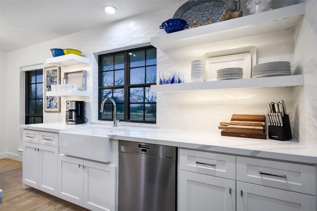6569 Cutoff Rd, Round Top, TX 78940 - kitchen featuring stainless steel dishwasher, open shelves, light stone countertops, and white cabinetry