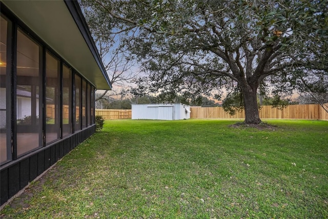 6569 Cutoff Rd, Round Top, TX 78940 - yard at dusk with a fenced backyard, a storage shed, and a sunroom
