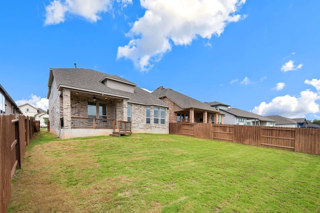1535 Terrys Gate, New Braunfels, TX 78132 - back of property with brick siding, a shingled roof, a fenced backyard, and a ceiling fan