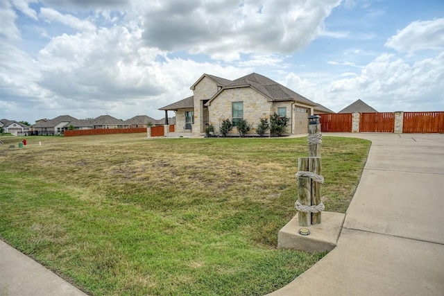 285 Chisholm Trl, Bastrop, TX 78602 - view of front of house featuring driveway, stone siding, a gate, and a garage
