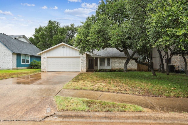 1808 Fawn Ridge Trl, Round Rock, TX 78681 - view of front facade with an attached garage, driveway, a front yard, stone siding, and board and batten siding