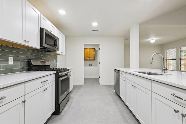 1808 Fawn Ridge Trl, Round Rock, TX 78681 - kitchen featuring stainless steel appliances, backsplash, light countertops, white cabinets, and recessed lighting