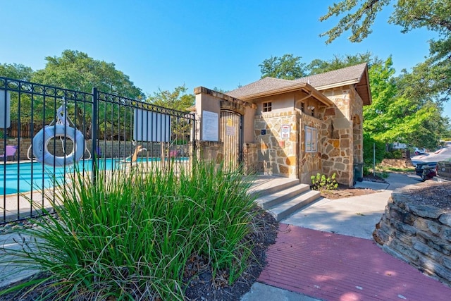 11400 W Parmer Ln Unit 75, Cedar Park, TX 78613 - exterior space with stone siding, a community pool, and stucco siding