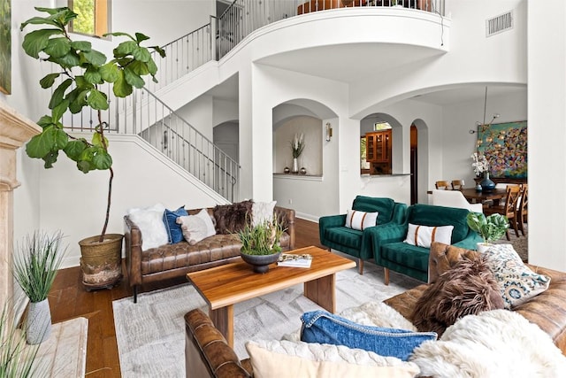 8540 Adirondack Trl Unit 21, Austin, TX 78759 - living area featuring a high ceiling, wood finished floors, arched walkways, and stairway