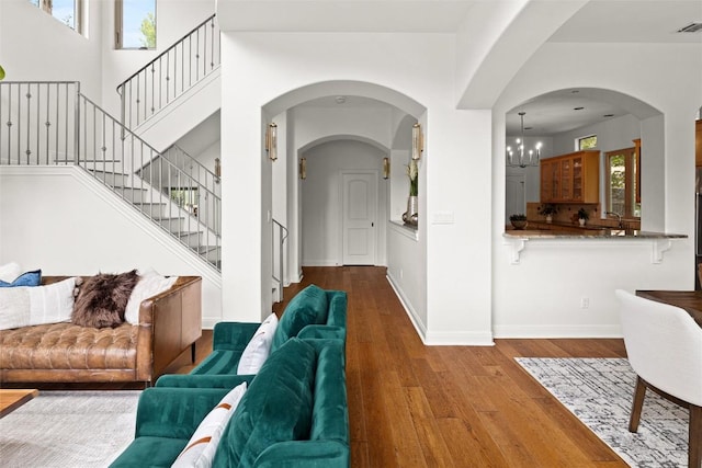 8540 Adirondack Trl Unit 21, Austin, TX 78759 - living room with wood finished floors, stairway, and arched walkways