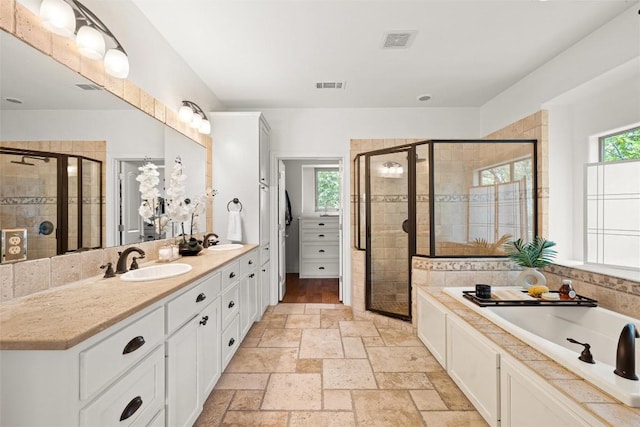 8540 Adirondack Trl Unit 21, Austin, TX 78759 - bathroom featuring healthy amount of natural light, a garden tub, and a shower stall