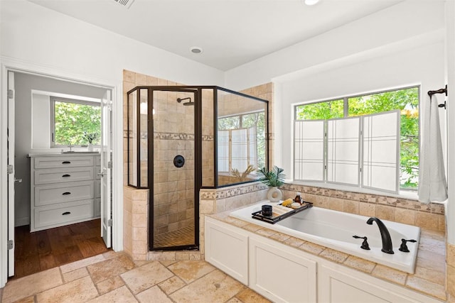 8540 Adirondack Trl Unit 21, Austin, TX 78759 - bathroom with a garden tub, a shower stall, stone tile floors, and recessed lighting