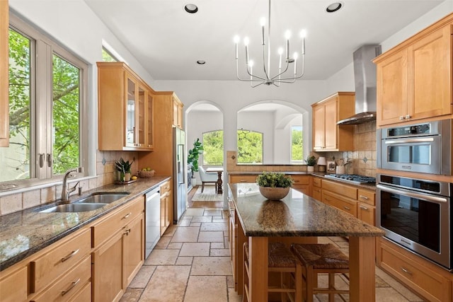 8540 Adirondack Trl Unit 21, Austin, TX 78759 - kitchen featuring wall chimney range hood, stone tile flooring, stainless steel appliances, healthy amount of natural light, and recessed lighting