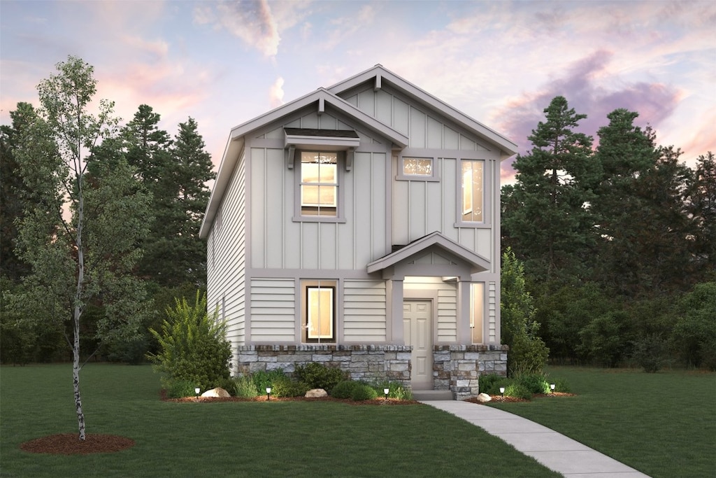 2022 Alice Jay Way, Round Rock, TX 78665 - view of front of property with board and batten siding, a lawn, and stone siding