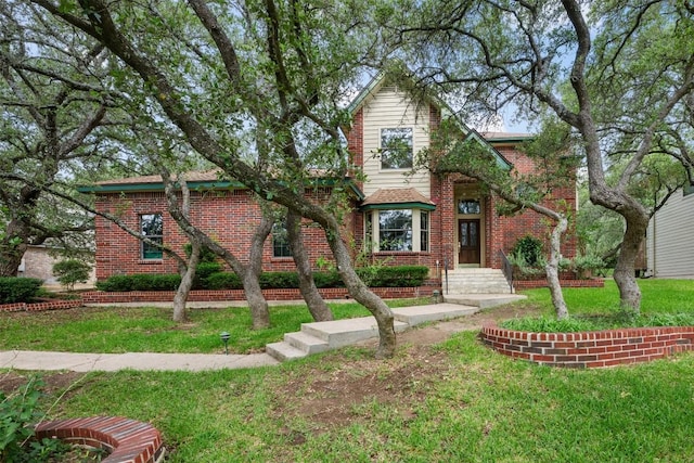 125 Long Wood Ave, Lakeway, TX 78734 - view of front of house featuring brick siding and a front lawn