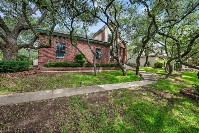 125 Long Wood Ave, Lakeway, TX 78734 - view of side of home featuring brick siding and a lawn