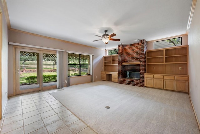 125 Long Wood Ave, Lakeway, TX 78734 - unfurnished living room featuring a ceiling fan, a fireplace, light tile patterned flooring, crown molding, and light colored carpet