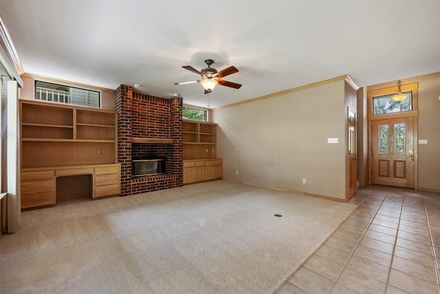 125 Long Wood Ave, Lakeway, TX 78734 - unfurnished living room with ornamental molding, ceiling fan, healthy amount of natural light, tile patterned flooring, and built in desk