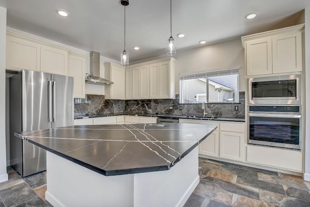 309 Camperdown Elm Dr, Austin, TX 78748 - kitchen featuring stainless steel appliances, wall chimney exhaust hood, dark countertops, tasteful backsplash, and recessed lighting