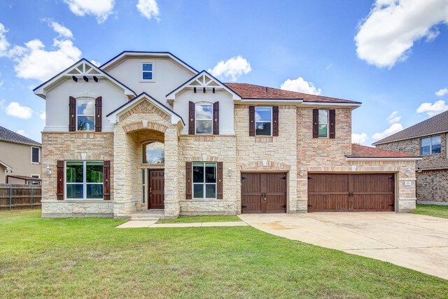 309 Camperdown Elm Dr, Austin, TX 78748 - view of front facade featuring stucco siding, driveway, stone siding, and a garage
