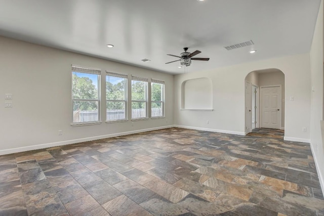 309 Camperdown Elm Dr, Austin, TX 78748 - unfurnished room with ceiling fan, arched walkways, stone tile flooring, and recessed lighting