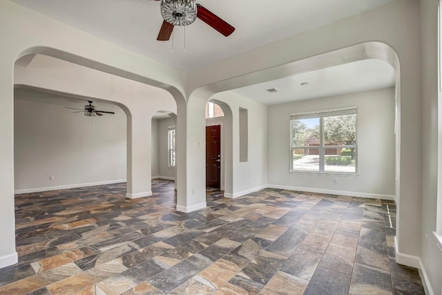 309 Camperdown Elm Dr, Austin, TX 78748 - spare room with ceiling fan, stone tile floors, and arched walkways