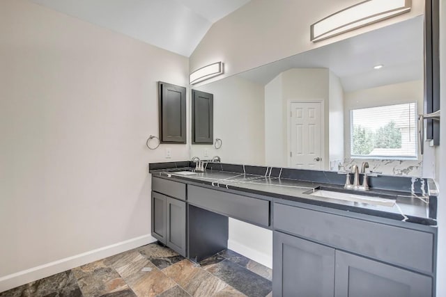 309 Camperdown Elm Dr, Austin, TX 78748 - bathroom with double vanity, stone finish flooring, and vaulted ceiling