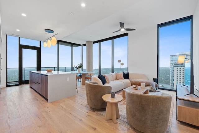84 E Ave Unit 4004, Austin, TX 78701 - living room with expansive windows, light wood-style floors, and a ceiling fan