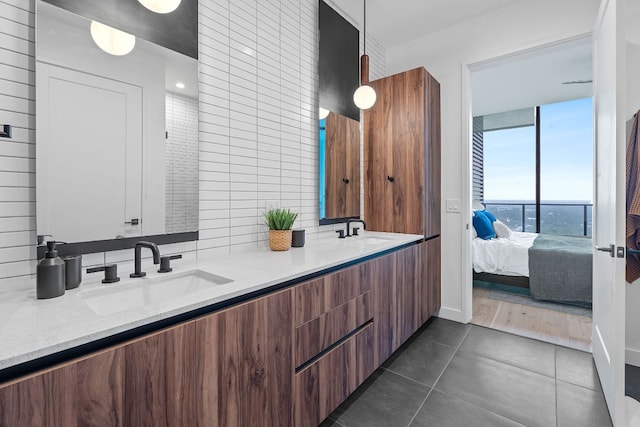 84 E Ave Unit 4004, Austin, TX 78701 - ensuite bathroom featuring double vanity, tile patterned floors, and backsplash