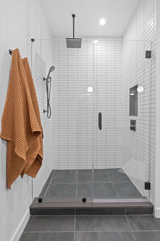 84 E Ave Unit 4004, Austin, TX 78701 - full bath with a shower stall, tile patterned flooring, and recessed lighting