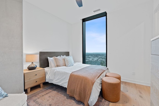 84 E Ave Unit 4004, Austin, TX 78701 - bedroom featuring wood finished floors, floor to ceiling windows, and ceiling fan