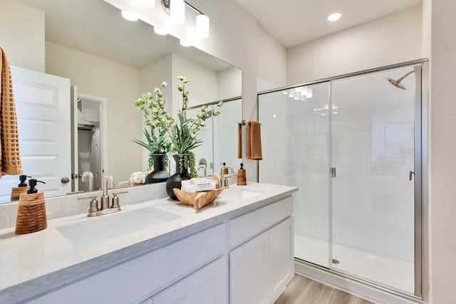 2420 Ekvall Dr, Round Rock, TX 78665 - full bath with double vanity, a shower stall, and wood finished floors