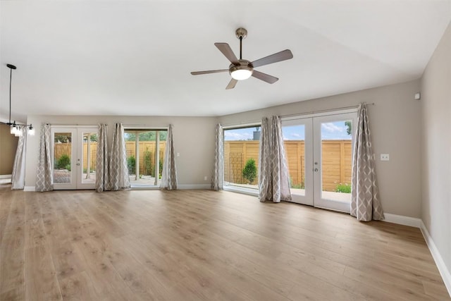 315 Comet, Lakeway, TX 78734 - unfurnished living room with french doors, light wood-style flooring, and a ceiling fan