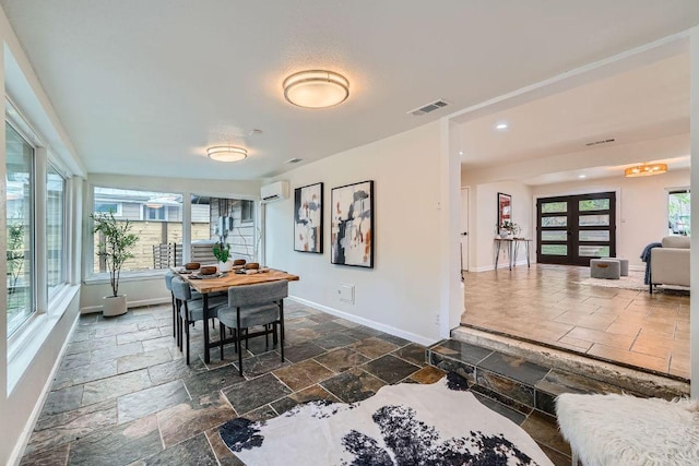 3501 Fleetwood Dr, Austin, TX 78704 - dining area featuring stone tile flooring, a wall unit AC, and recessed lighting