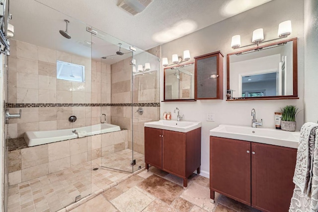 3501 Fleetwood Dr, Austin, TX 78704 - bathroom with a stall shower, two vanities, tiled tub, and stone finish flooring